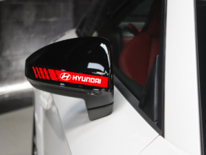 Detailed close-up of Hard Goat Hyundai side mirror sticker, red racing stripes and white logo